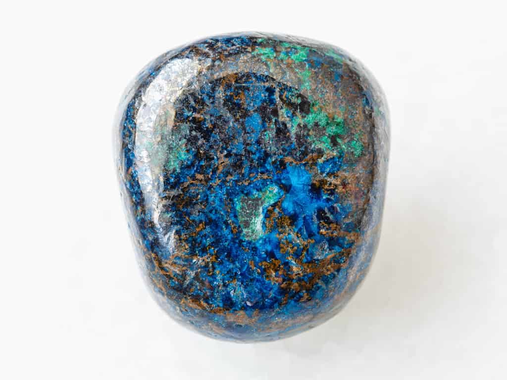 macro shooting of natural mineral rock specimen - polished Azurite gemstone on white marble background