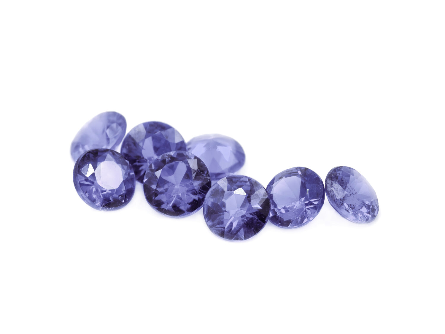 Purple diamond cut gems on a white background.