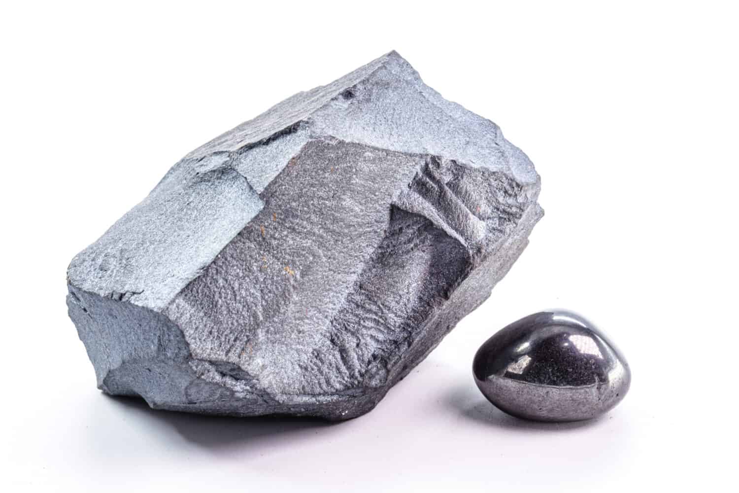 hematite stones, polished stone and rough stone, on isolated white background